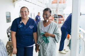 Salematu, maxillofacial patient, walking with ward nurse, Sarah Johnson, on Deck 7.